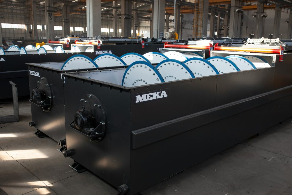 Large industrial machinery inside a modern manufacturing plant with natural lighting.